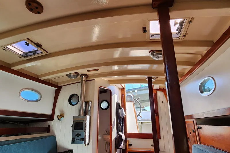 Slide: The Image of Interior of 1996 Tillotson-Pearson Motorsailer 32, featuring wood accents and nautical decor. - 69