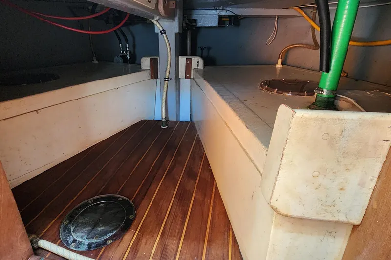 Slide: The Image of Interior view of a 1996 Tillotson-Pearson Motorsailer 32, showcasing storage and piping. - 70