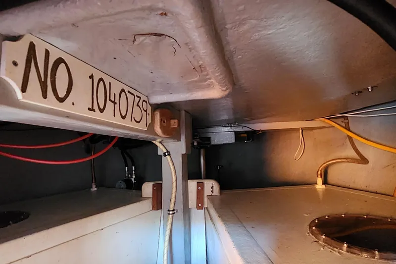 Slide: The Image of Interior view of 1996 Tillotson-Pearson Motorsailer 32, showing wiring and identification number. - 71
