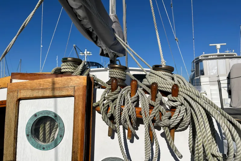 Slide: The Image of Ropes and cleats on a 1996 Tillotson-Pearson Motorsailer 32 sailboat deck. - 72