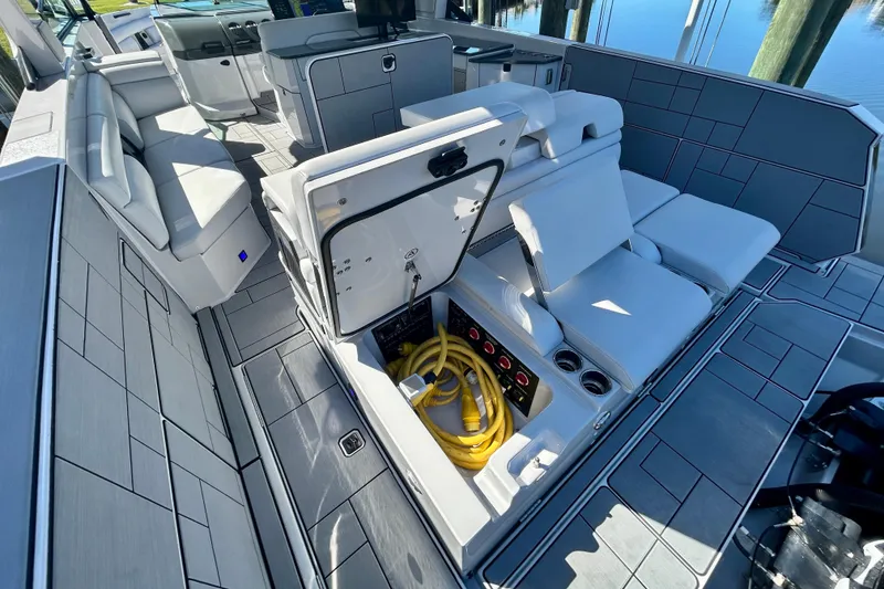 Slide: The Image of 2022 Aviara AV40 OB boat interior with storage compartment open, revealing yellow cables. - 13