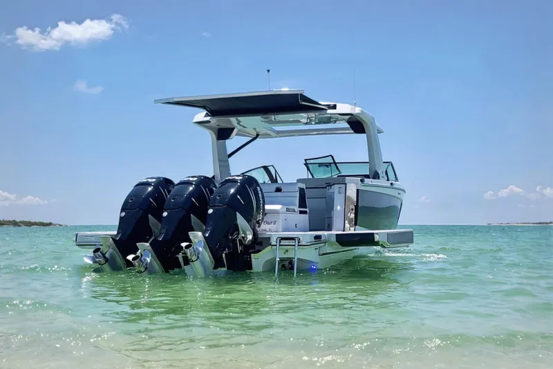 Slide: The Image of 2022 Aviara AV40 OB boat with triple outboard engines in clear blue water. - 2