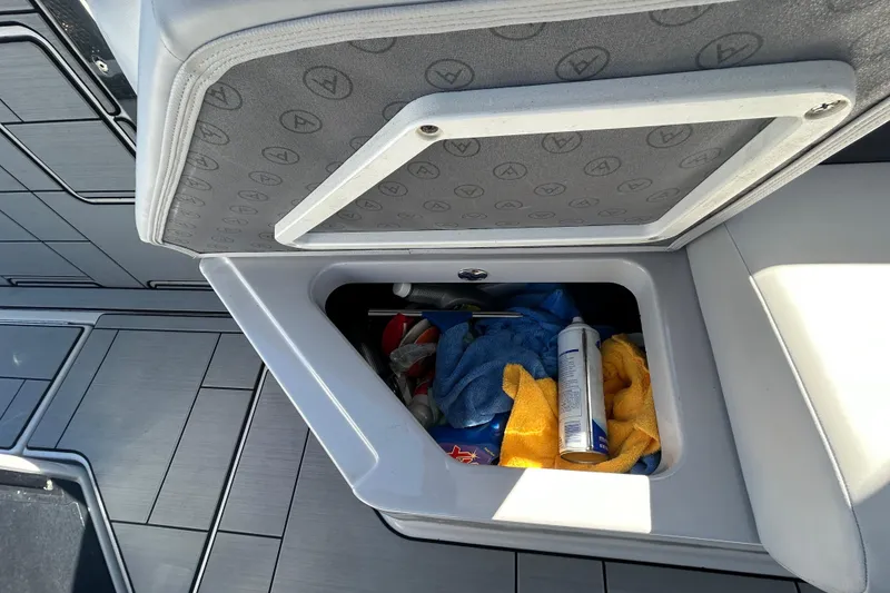 Slide: The Image of Storage compartment on 2022 Aviara AV40 OB boat with towels and cleaning supplies. - 21