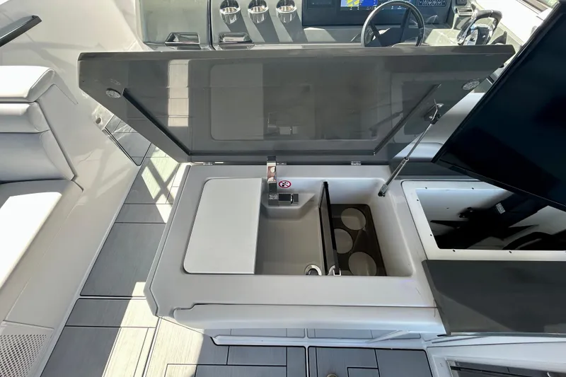 Slide: The Image of 2022 Aviara AV40 OB boat interior with open storage compartment and seating area. - 23