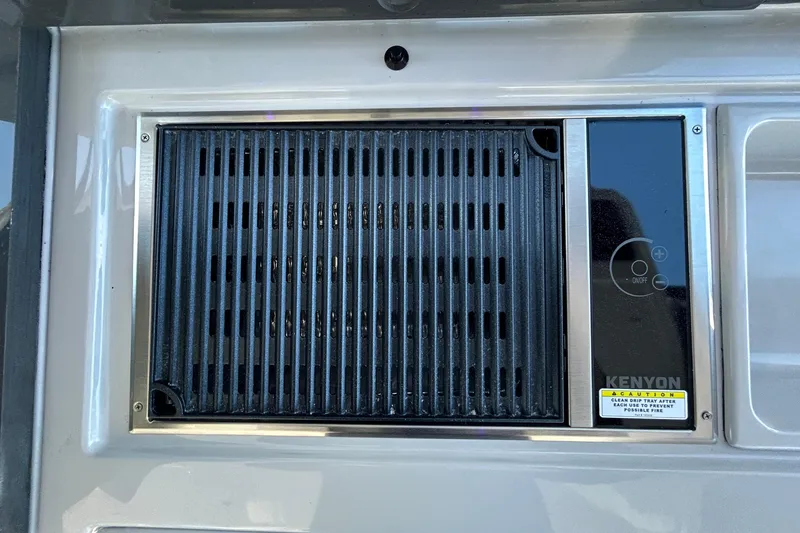 Slide: The Image of Built-in Kenyon grill on 2022 Aviara AV40 OB boat, featuring sleek design and control panel. - 24