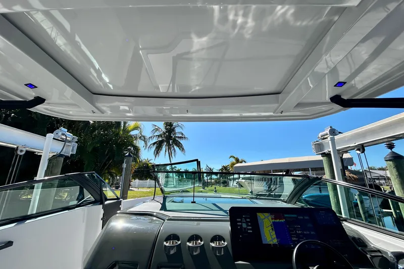 Slide: The Image of Interior view of 2022 Aviara AV40 OB boat with modern dashboard and open roof. - 28