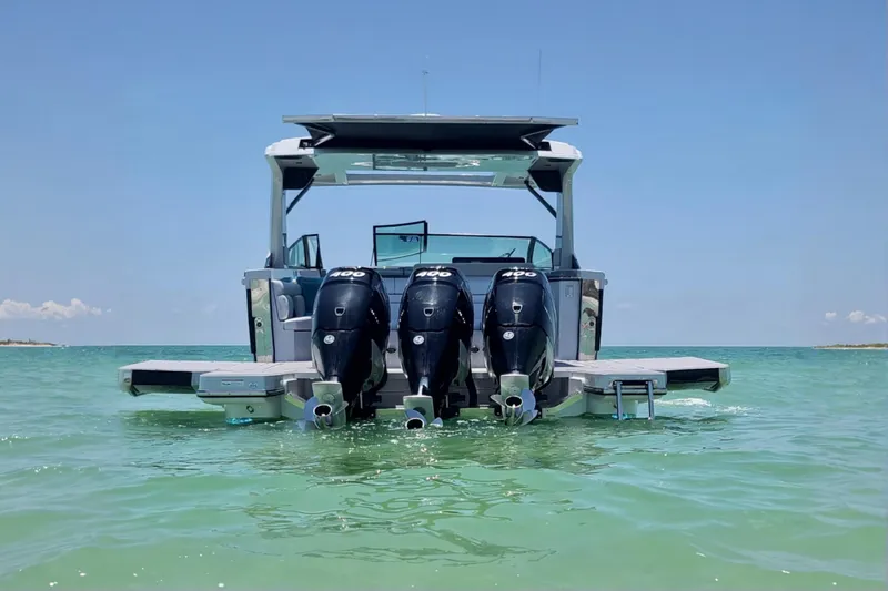 Slide: The Image of 2022 Aviara AV40 OB boat with triple outboard engines on clear water. - 3