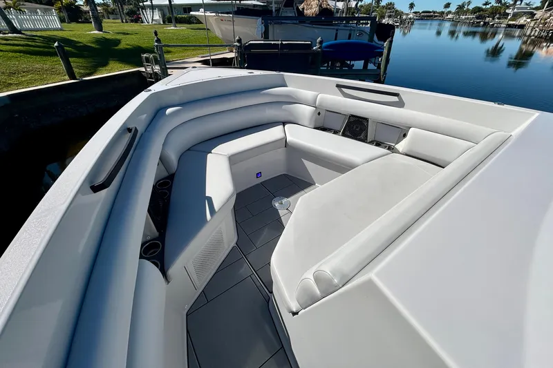 Slide: The Image of 2022 Aviara AV40 OB boat with spacious white seating area docked by calm waters. - 36
