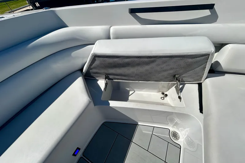Slide: The Image of 2022 Aviara AV40 OB boat interior with open storage compartment and cushioned seating. - 37