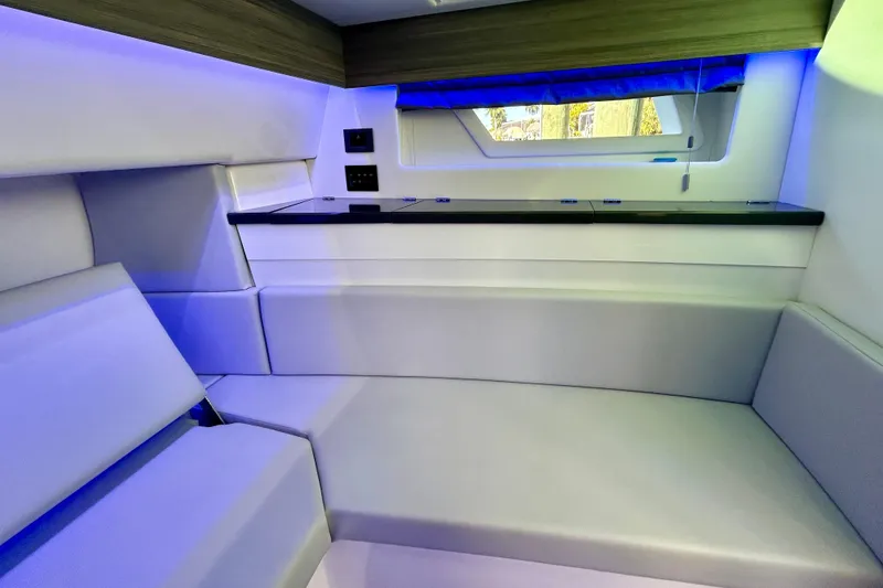 Slide: The Image of Interior of 2022 Aviara AV40 OB boat with modern seating and ambient lighting. - 48