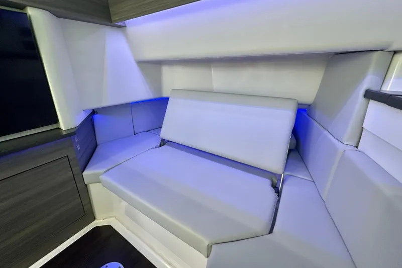 Slide: The Image of Luxurious interior seating of 2022 Aviara AV40 OB boat with ambient blue lighting. - 49