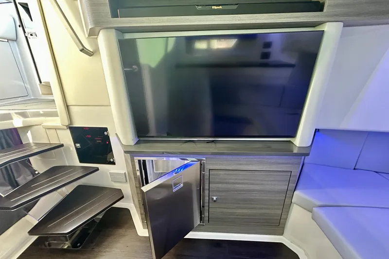 Slide: The Image of Interior of 2022 Aviara AV40 OB boat with TV, fridge, and modern seating. - 51