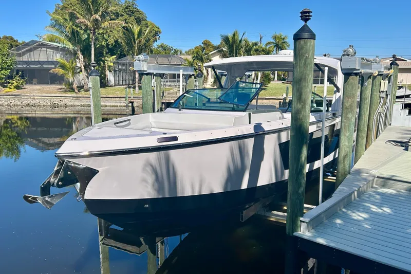 Slide: The Image of 2022 Aviara AV40 OB boat docked in a serene waterfront setting. - 6
