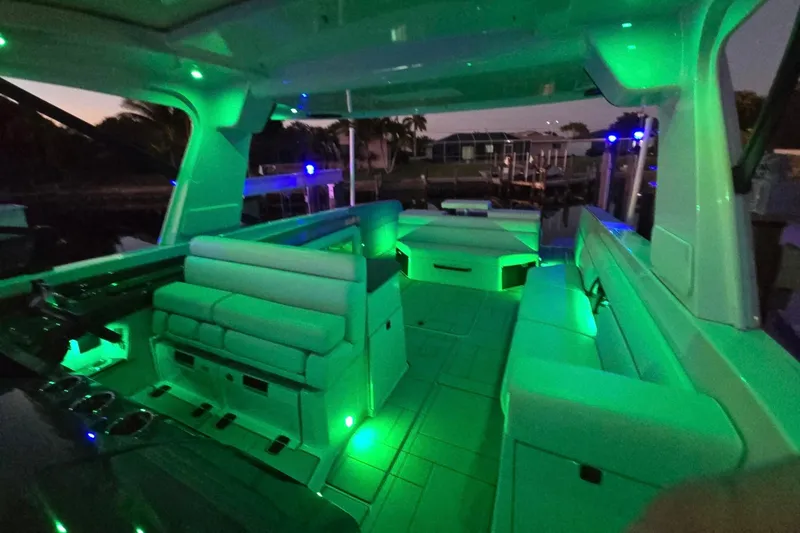 Slide: The Image of 2022 Aviara AV40 OB boat interior with green ambient lighting at dusk. - 66