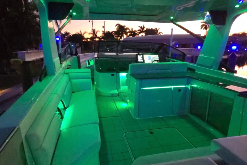 Slide: The Image of Luxurious 2022 Aviara AV40 OB boat interior with ambient green lighting at sunset. - 67