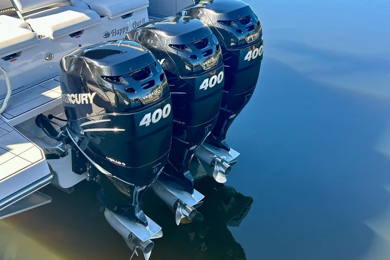 Slide: The Image of 2022 Aviara AV40 OB with triple Mercury 400 outboard engines on calm water. - 7