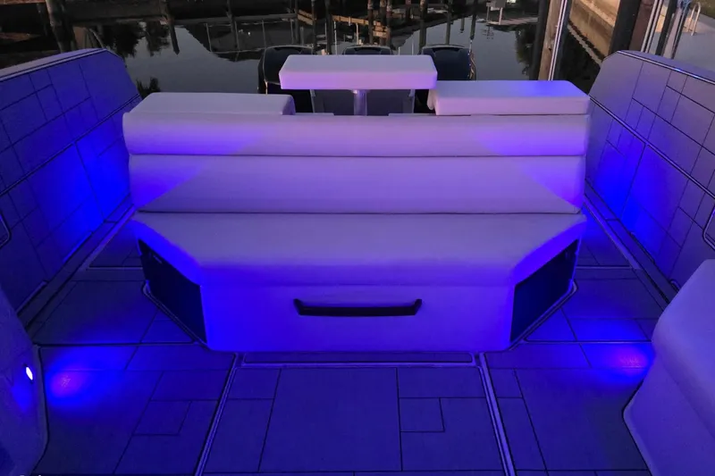 Slide: The Image of 2022 Aviara AV40 OB boat interior with blue LED lighting and white seating. - 70