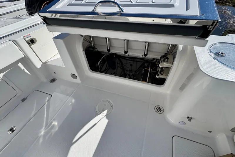 Slide: The Image of 2026 Robalo R250 Center Console boat interior with open storage compartment. - 13