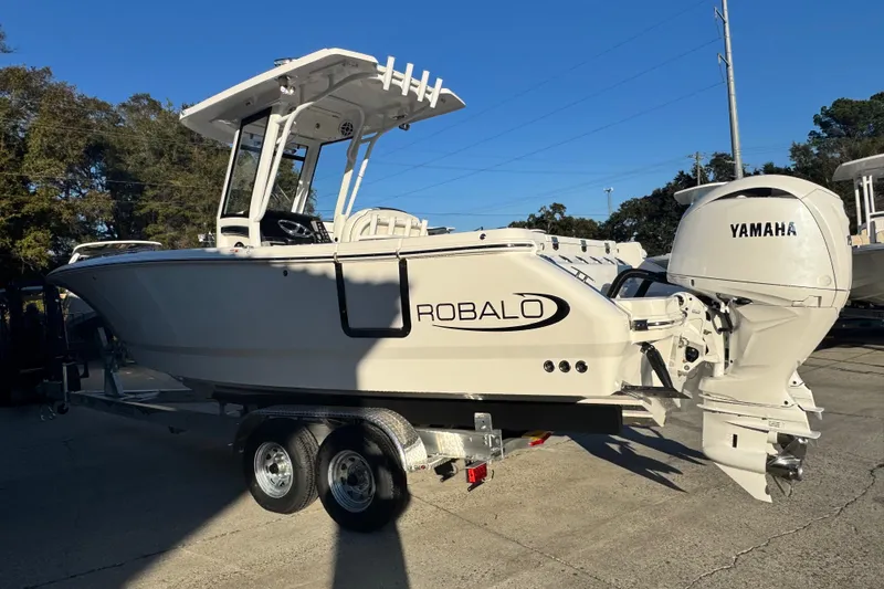 Slide: The Image of 2026 Robalo R250 Center Console boat with Yamaha engine on trailer. - 2