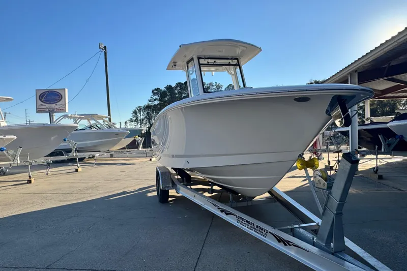 Slide: The Image of 2026 Robalo R250 Center Console boat on trailer in sunny outdoor setting. - 4