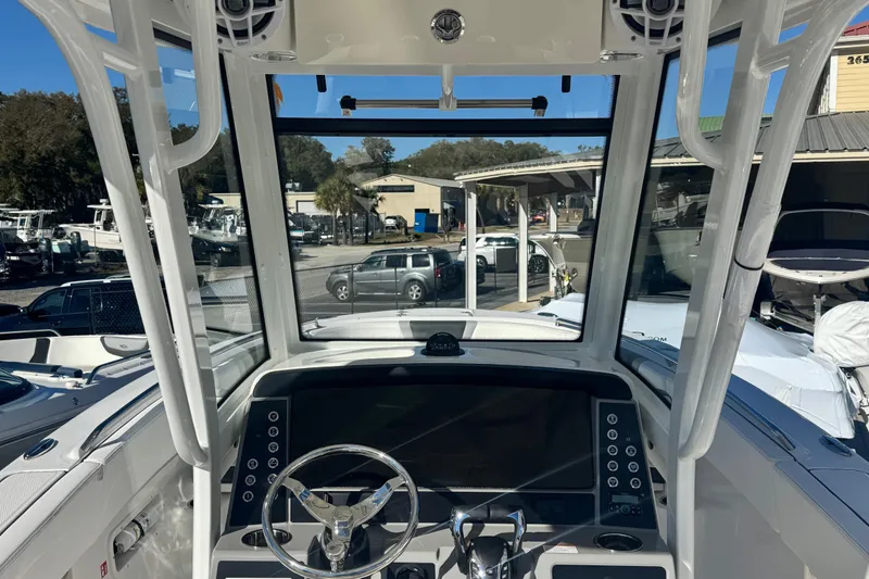 Slide: The Image of 2026 Robalo R250 Center Console boat dashboard with steering wheel and controls. - 5