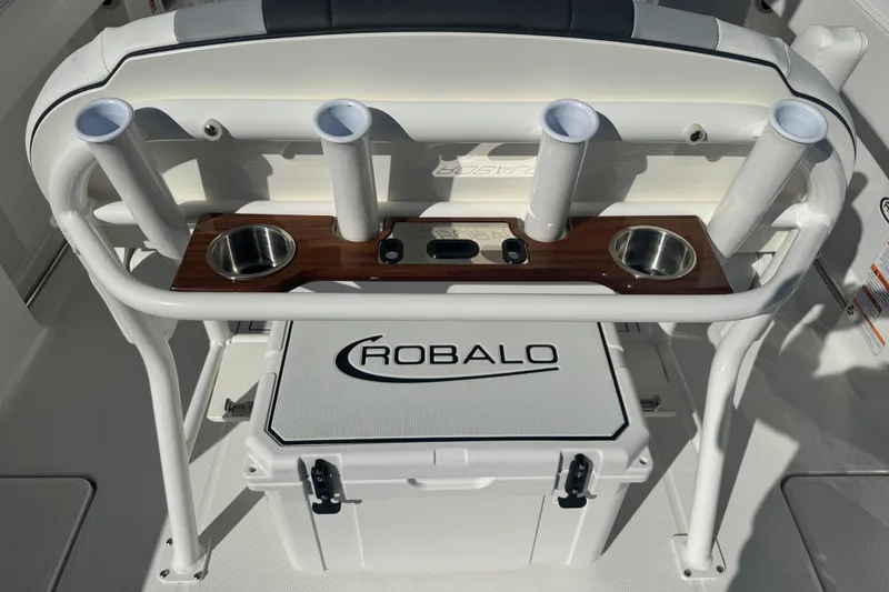 Slide: The Image of 2026 Robalo R250 Center Console boat interior with rod holders and cooler. - 6