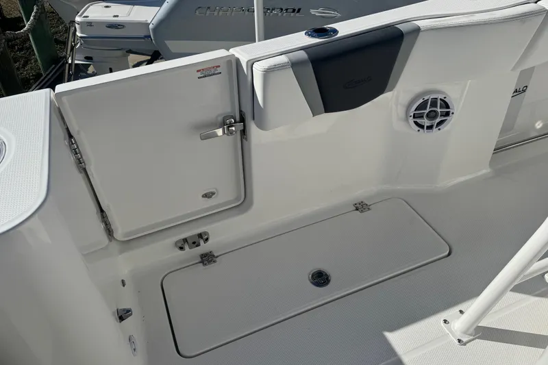 Slide: The Image of 2026 Robalo R250 Center Console boat interior with storage compartment and speaker. - 7