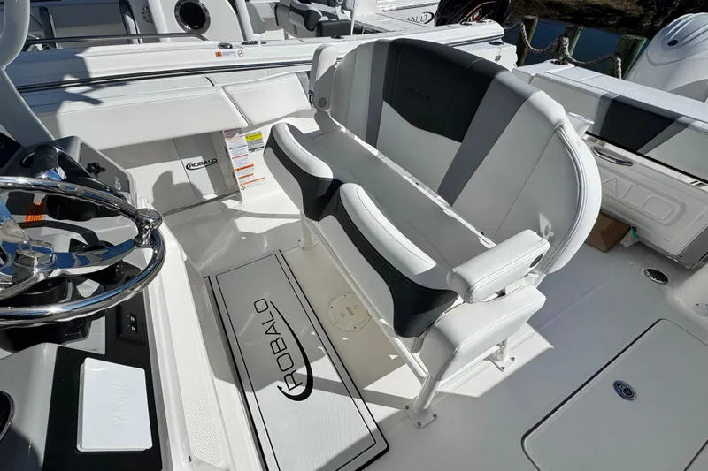 Slide: The Image of 2026 Robalo R250 Center Console boat interior with steering wheel and seating. - 9