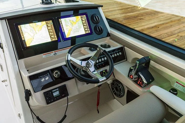 Slide: The Image of Manufacturer Provided Image: 2025 Boston Whaler 330 Vantage helm with dual navigation screens and modern controls. - 8