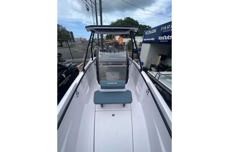 Slide: The Image of 2026 Axopar 22 T-Top boat interior with seating and T-top canopy. - 2
