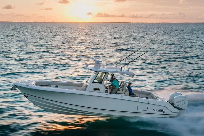 Slide: The Image of Manufacturer Provided Image: 2025 Boston Whaler 330 Outrage cruising at sunset on open water. - 2