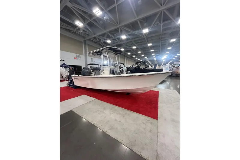 The Image of 2026 May-Craft 208 CC boat displayed indoors on red carpet at a boat show. - 0