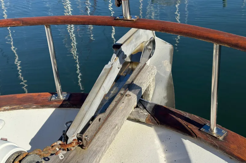 Slide: The Image of Bow of 1986 Newburyport 37 boat with anchor chain and wooden railings. - 10