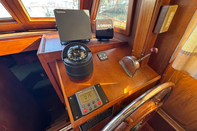 Slide: The Image of Wooden helm station of 1986 Newburyport 37 with navigation instruments and compass. - 15