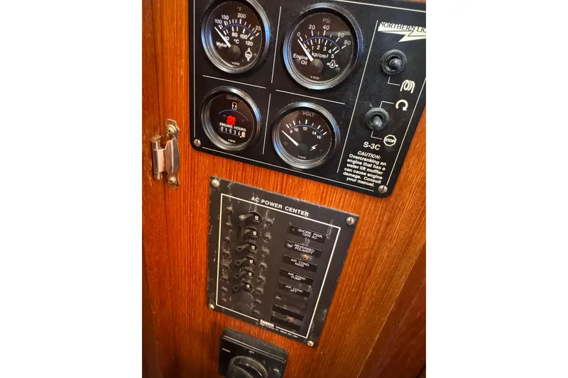 Slide: The Image of Control panel of a 1986 Newburyport 37 boat with gauges and switches. - 16