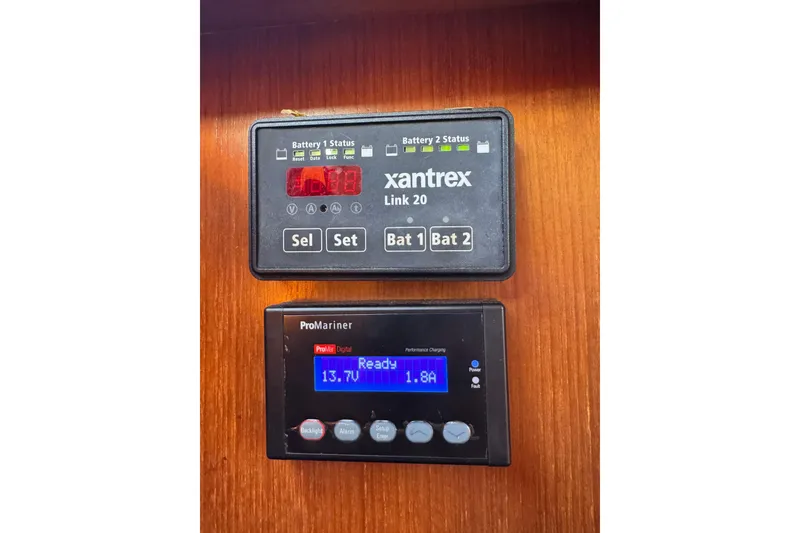 Slide: The Image of Battery monitors on a 1986 Newburyport 37, displaying voltage and amperage readings. - 17
