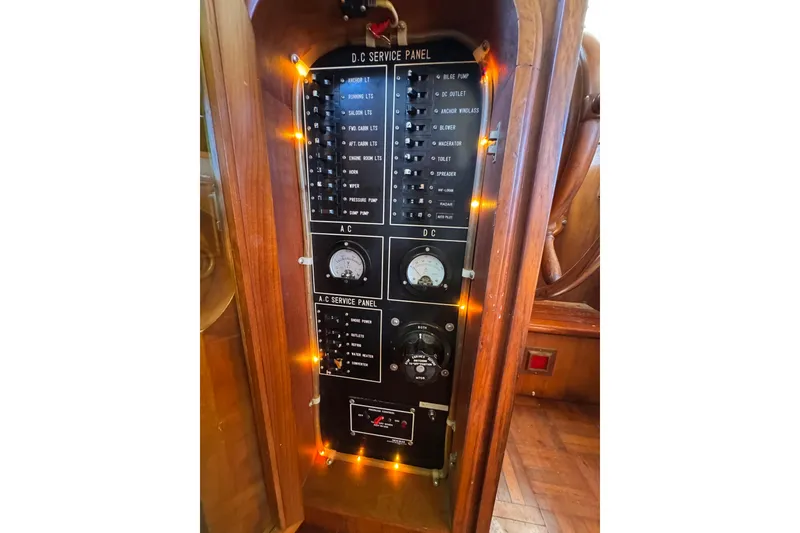 Slide: The Image of Electrical service panel on a 1986 Newburyport 37 boat, featuring AC and DC controls. - 18