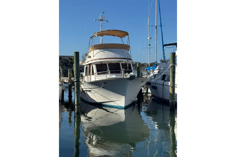 Slide: The Image of 1986 Newburyport 37 boat docked in marina, reflecting on calm water. - 2