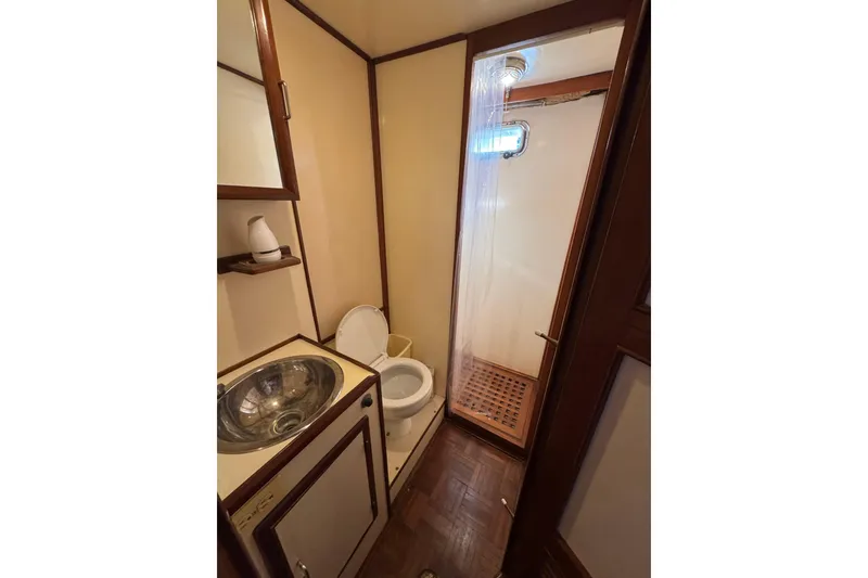 Slide: The Image of Compact bathroom in 1986 Newburyport 37 boat with sink, toilet, and shower. - 29