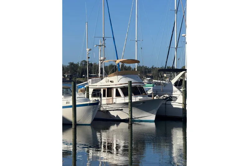 Slide: The Image of 1986 Newburyport 37 yacht docked at marina, surrounded by other boats. - 3