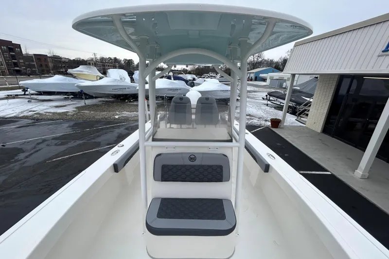 Slide: The Image of 2026 May-Craft 245 Offshore CC boat in snowy marina, showcasing center console design. - 14