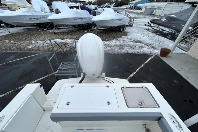 Slide: The Image of 2026 May-Craft 245 Offshore CC boat in snowy marina, surrounded by covered vessels. - 21