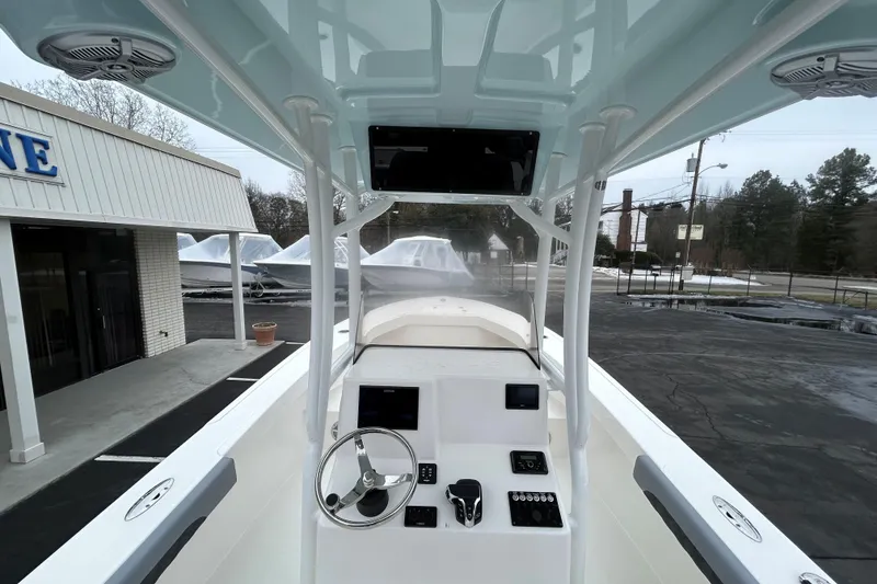Slide: The Image of 2026 May-Craft 245 Offshore CC boat interior with steering wheel and control panel. - 7