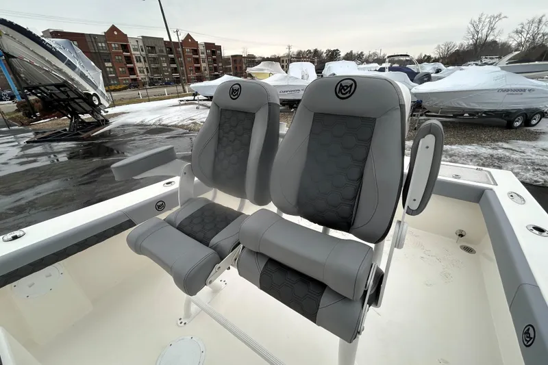 Slide: The Image of 2026 May-Craft 245 Offshore CC boat seats, gray upholstery, outdoor setting. - 8