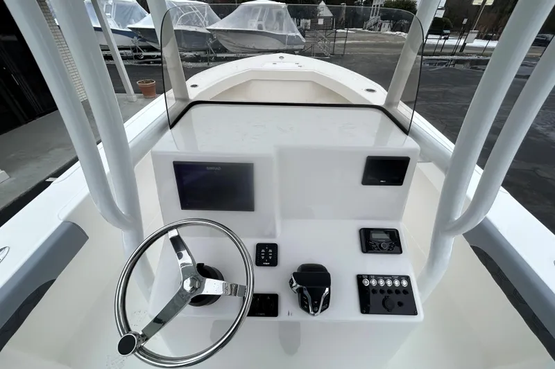 Slide: The Image of 2026 May-Craft 245 Offshore CC boat console with steering wheel and navigation controls. - 9