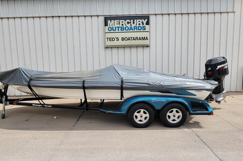 Slide: The Image of Covered 2000 Ranger 522DVX Comanche boat on trailer, parked outside Ted's Boatarama. - 1