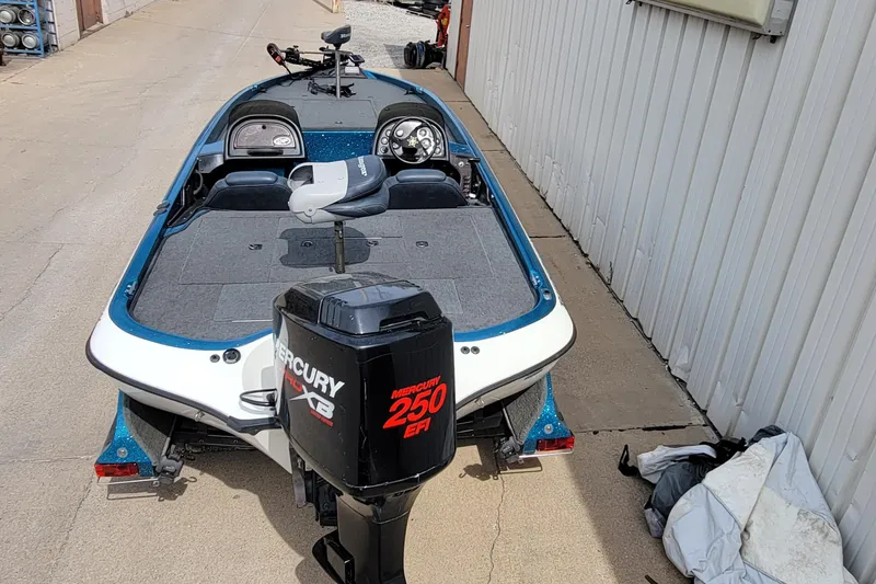 Slide: The Image of 2000 Ranger 522DVX Comanche boat with Mercury 250 EFI engine, parked beside a building. - 10