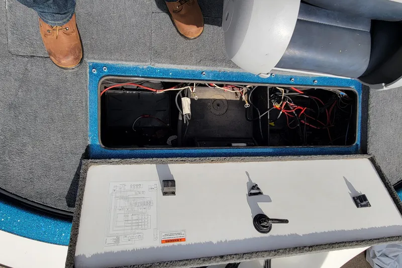 Slide: The Image of Open hatch of a 2000 Ranger 522DVX Comanche boat showing internal wiring and components. - 24