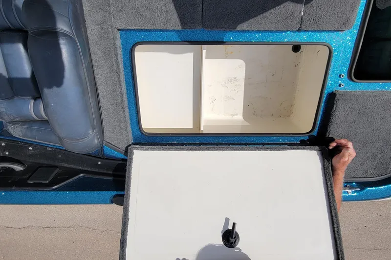 Slide: The Image of Open storage compartment in 2000 Ranger 522DVX Comanche boat, showing interior details. - 26