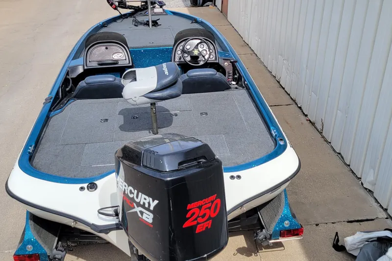 Slide: The Image of 2000 Ranger 522DVX Comanche boat with Mercury 250 EFI engine, parked on concrete. - 3